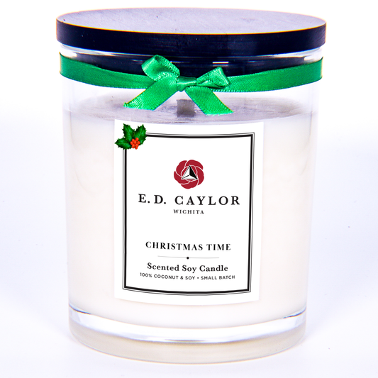 Scented candle with a green ribbon and E.D. Caylor label on a white background